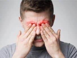 a man experiencing sharp pain in the eye